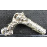 A Victorian white metal/silver plated walking cane handle depicting a young child sleeping within a