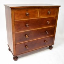 A Victorian mahogany chest of two short and three long drawers, raised on bun feet,