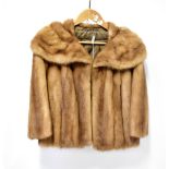 A light brown fur jacket, with wide collar and light brown satin lining, length approx 58cm.