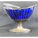 A hallmarked silver sweetmeat basket with blue glass liner, hinged handle, wire-framed body,
