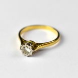 An 18ct yellow gold diamond ring, the small illusion set diamond on a crown mount, size O, approx 2.