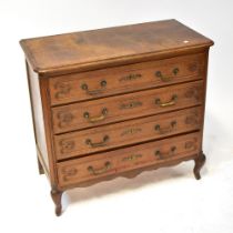 An early 20th century oak chest of four drawers with carved detail to the drawer fronts,