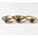 Three 9ct gold cluster rings comprising an example set with amethyst-coloured stone within a flower