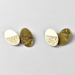 A pair of 9ct gold cufflinks, the oval cufflinks with half diagonal floral design,