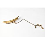 An Edwardian-style long crescent brooch with graduated small seed pearls,