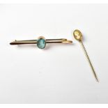 A 9ct gold bar brooch with bezel set oval blue stone, possibly aquamarine, on a bar brooch,