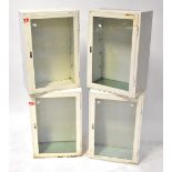 Four white metal industrial wall-hanging units with glazed cupboard doors, each 74 x 49 x 29cm (4).