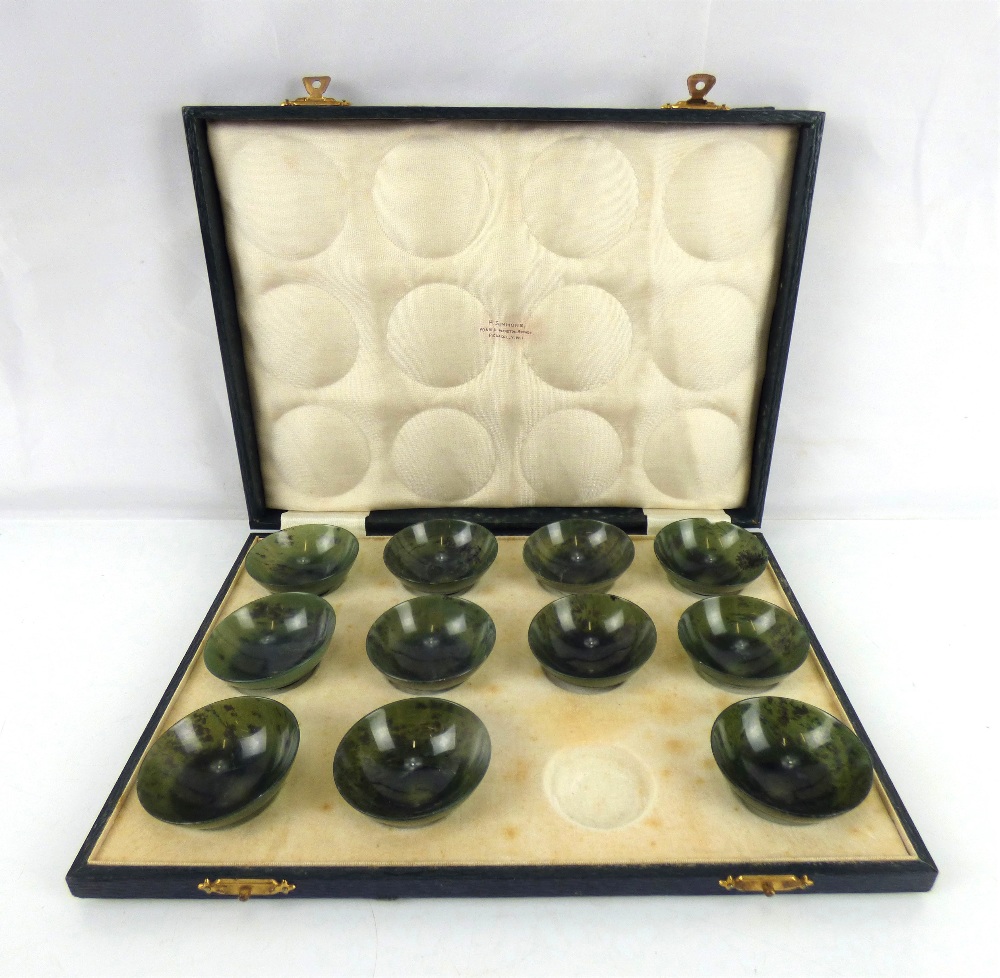 A late 19th/early 20th century set of eleven Chinese spinach jade circular bowls,