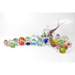 Twenty-four glass paperweights to include bubble, millefiori and swirl examples,