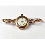 A ladies' vintage 9ct gold crown wind wristwatch, the white enamelled dial set with Arabic numerals,