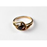 A 9ct rose gold garnet ring, the four-claw set small cut garnet in a crossover scroll mount, size N,