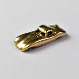 A 9ct gold pendant in the form of an E-type Jaguar, length approx 2.5cm, width 1cm, approx 6.5g.