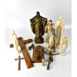 A group of religious figures including a brass crucifix, plaster figure, etc.