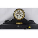 A 19th century black slate clock with barrel movement,