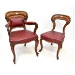 A set of ten Victorian mahogany balloon back chairs with red leatherette upholstered stuff-over