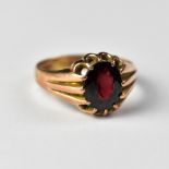 A Victorian-style 9ct rose gold signet ring with claw set oval garnet, three fluted shoulders,