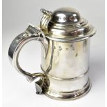 A George I hallmarked silver tankard with scroll thumbpiece and handle,