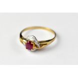 A 9ct gold ruby ring with claw set oval cut ruby, in a white gold crossover mount,
