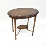 An Edwardian mahogany oval occasional table, the moulded top above dentil moulded frieze,