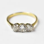 A 14ct gold ring set with three brilliant cut diamonds in claw settings, hallmarked '585', size O,