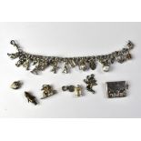 A hallmarked silver charm bracelet with twenty silver charms, length approx 18cm,