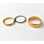 Three wedding bands comprising a 22ct gold wide ring, size S, approx 5g, an 18ct white gold ring,