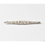 An early 20th century diamond set white metal bar brooch,