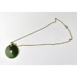 A Chinese circular disc jade-style pendant with 10ct (10K) mounts and necklace hoop,