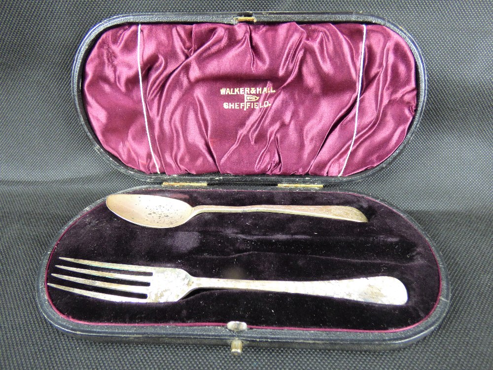 An Edwardian hallmarked silver spoon and fork set with bright cut decoration, Walker & Hall,