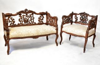 An early 20th century Italian ornately carved walnut three-piece salon suite of small proportions,