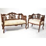 An early 20th century Italian ornately carved walnut three-piece salon suite of small proportions,