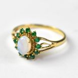 A modern 9ct gold ring with a claw set oval white opal,