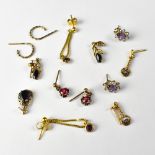 Six pairs of gold and other earrings, mostly studs with small white and coloured stones,