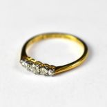 An 18ct gold five stone graduated diamond ring, the principal diamond approx 0.