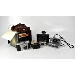 Four cameras comprising a Polaroid Super Swinger Land camera in original box,