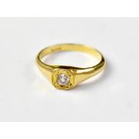 An 18ct gold ring with a square mount set with a small diamond chip, size N, approx 3g.