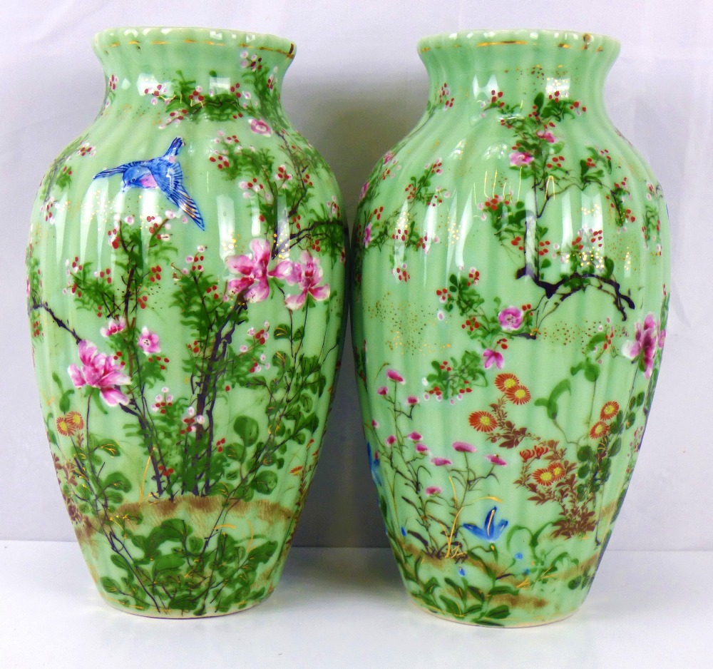 A pair of early 20th century Japanese green glaze vases of baluster form and ribbed body,