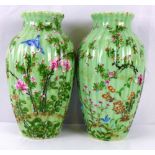 A pair of early 20th century Japanese green glaze vases of baluster form and ribbed body,