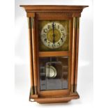 WITHDRAWN A 1940s oak wall clock, the silvered chapter ring set with Arabic numerals,