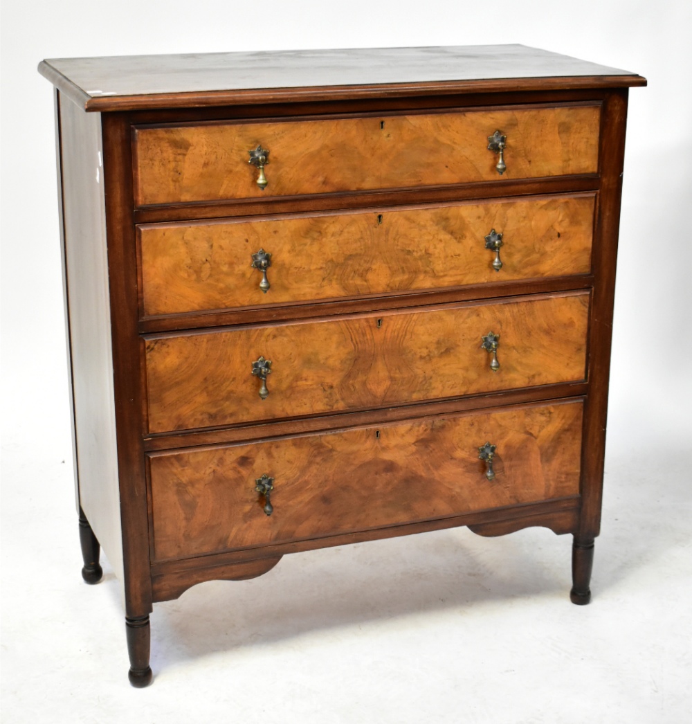 A mahogany and walnut chest of four long graduated drawers, raised on turned feet, width 110cm.