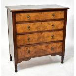 A mahogany and walnut chest of four long graduated drawers, raised on turned feet, width 110cm.