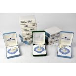 WEDGWOOD; twelve boxed pale blue Jasper ware Christmas decorations in the form of roundels,