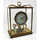 KUNDO; a brass anniversary clock with graduated grey dial, under a glass case,