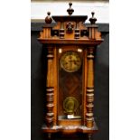 A walnut cased spring-driven Vienna wall clock, the architectural upper section with applied mask,