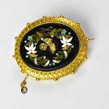 A 19th century mourning brooch with a large oval pietra dura panel depicting a gold centred flower