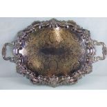 A large silver on copper serving tray in the Rococo manner, with scroll,
