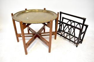 An Indian brass circular table on folding stand and a magazine rack (2).