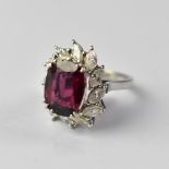 An 18ct white gold ruby (possibly synthetic) and diamond ring,