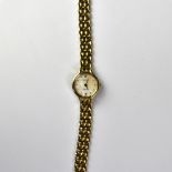 TISSOT; a ladies' 9ct gold wristwatch, the pearlescent dial set with raised gold baton numerals,