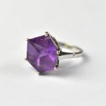 A 9ct white gold amethyst ring, the claw set amethyst cut as a 3D cube form, in a cathedral mount,